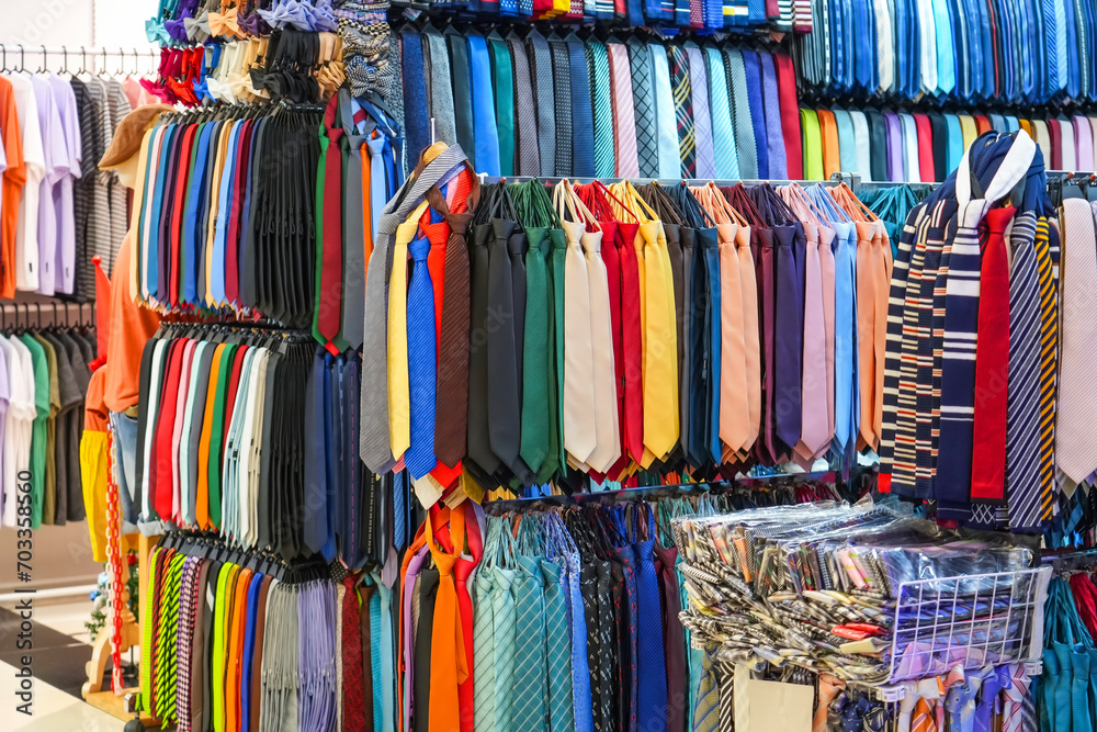 Many different ties of multi colors on display at the exhibition showcase. Large assortment of items for customers to choose from