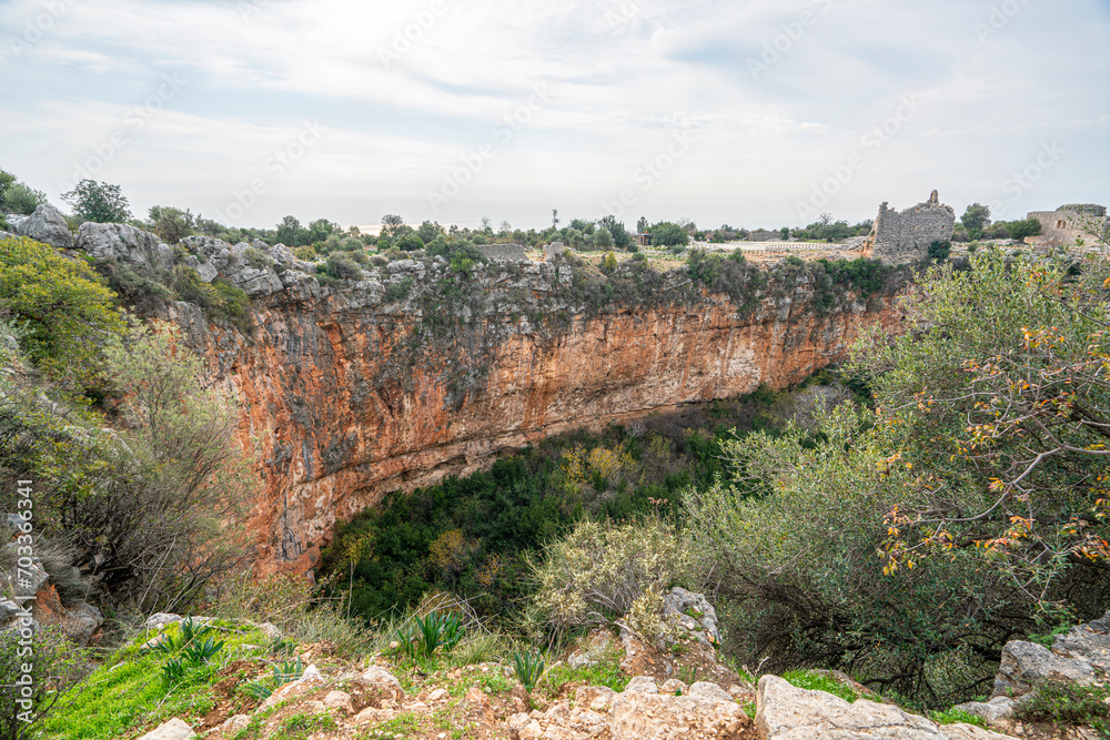 Fototapeta premium Amazing views from Kanlıdivane (ancient Canytelis), which is an ancient city situated around a big sinkhole in Mersin, Turkey.