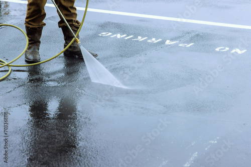 Street is sprayed with pressurized water to be cleaned, road is washed by water