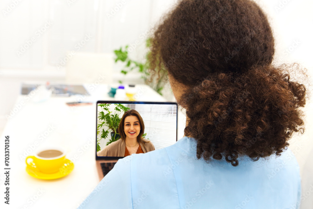 Shot of attractive afro female doctor talking while explaining medical treatment to patient through a video call Shot of attractive afro female doctor talking while explaining medical treatment to patient through a video call