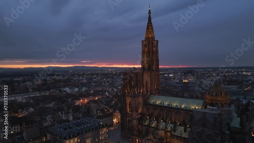 Establishing aerial close up view of Strasbourg Cathedral of Notre Dame and Petite France old french architecture and river with beautiful sunset view
