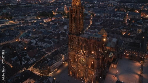 Aerial close up view of Strasbourg Cathedral of Notre Dame illuminated and Petite France old french buildings architecture with beautiful night sky view photo