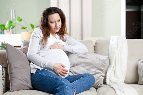 Young woman suffering from nausea and headache during pregnancy