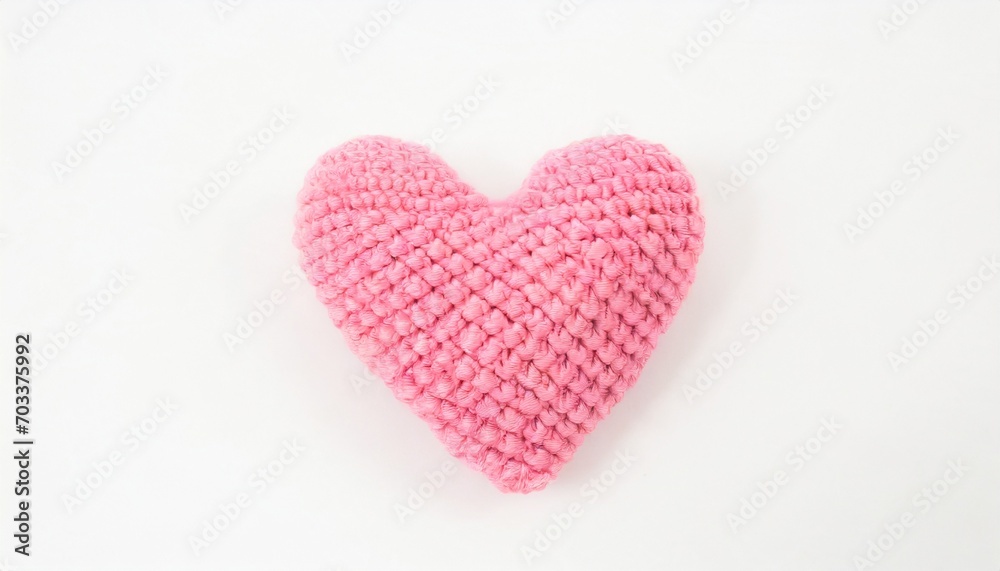 crocheted pink heart on a white background