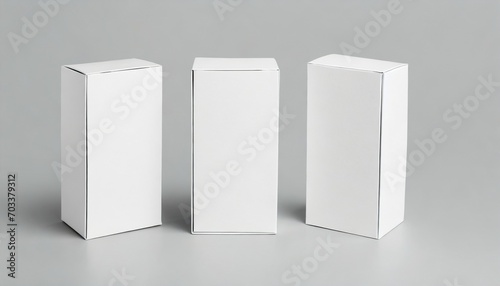 three white cardboard boxes mockup isolated on gray © Debbie