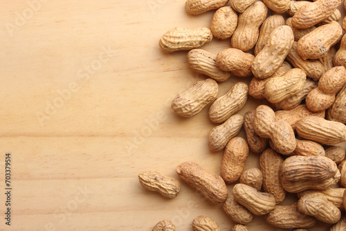 Fresh roasted peanuts on wooden table.