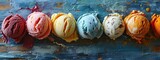 A colorful selection of ice cream scoops lined up on a textured background, showcasing a variety of delectable flavors.