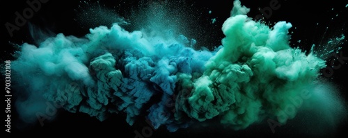 Explosion of teal colored powder on black background