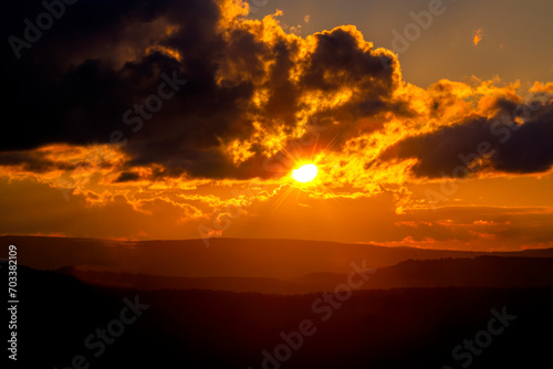 Sun setting on West Virginia Scenic Highway making orange sky