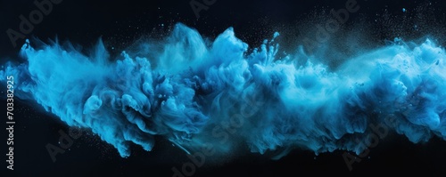 Explosion of sky blue colored powder on black background