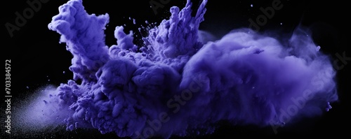 Explosion of periwinkle colored powder on black background 