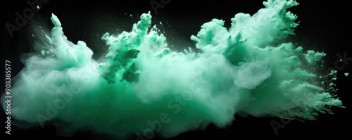 Explosion of mint colored powder on black background