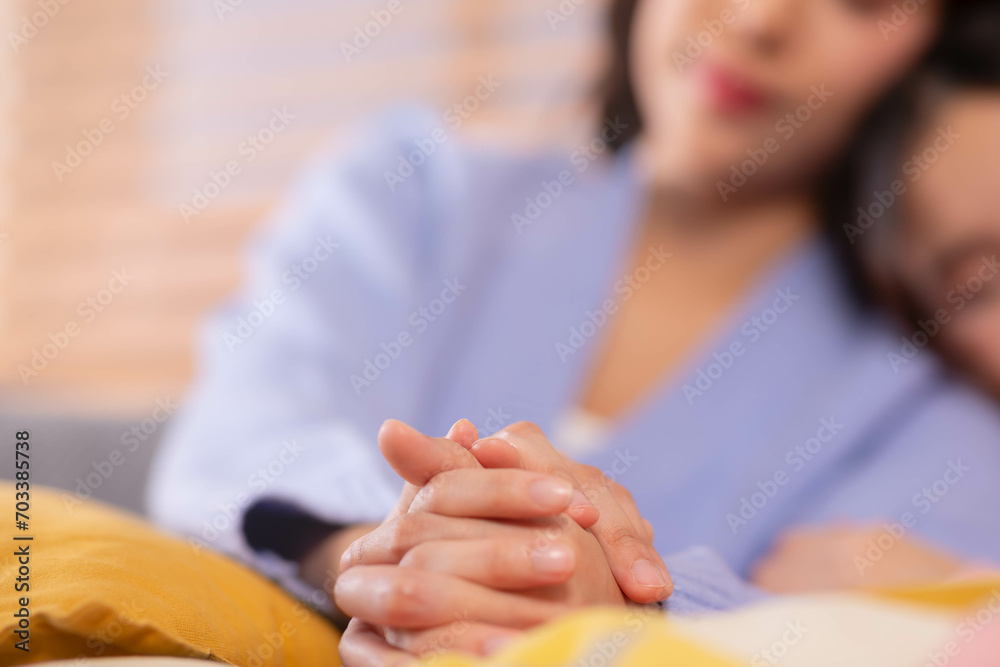 Selective focus on hands holding together of LGBT female lesbian, laying down on bed in bedroom at home. Showing no limited Love Concept Selective focus on hands holding together of LGBT female lesbian, laying down on bed in bedroom at home. Showing no limited Love Concept