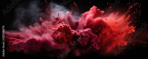 Explosion of maroon colored powder on black background