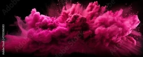 Explosion of magenta colored powder on black background