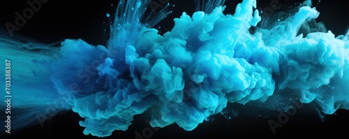 Explosion of cyan colored powder on black background