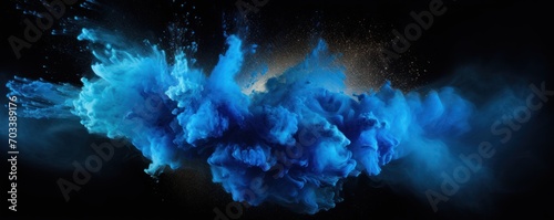 Explosion of blue colored powder on black background