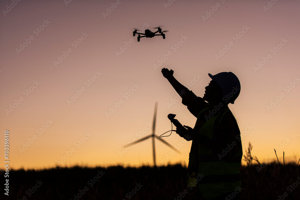 Silhouette of a person in wind turbine field. silhouette of a person in the sunset. silhouette of a person. Silhouette of a person in wind turbine field. silhouette of a person in the sunset. silhouette of a person.