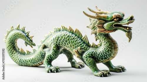 A detailed green ceramic dragon sculpture with intricate scales and an ornate design is showcased against a neutral background. © mashimara
