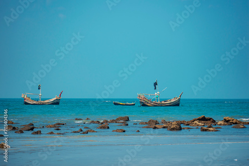 Traditional Fishing Boat Bobs on Serene Waters off Bangladesh Coast in St. Martin Island, Bangladesh