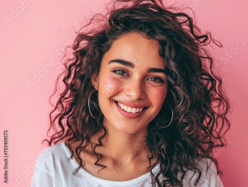 Beautiful woman smiling on pink background