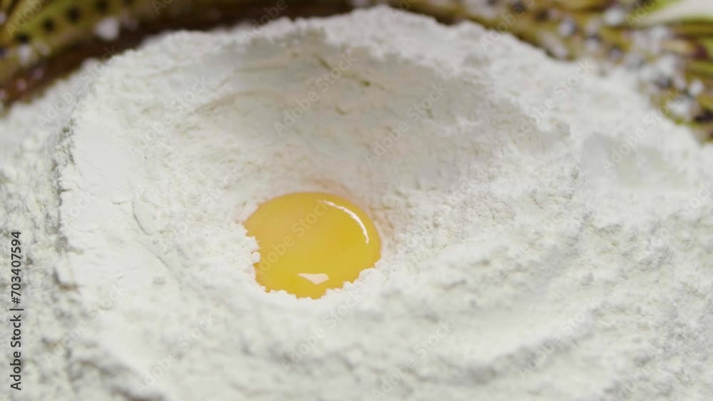 Super slow motion in a pile of flour falls a fresh egg. Top view.
Super slow motion in a pile of flour falls a fresh egg. Top view.