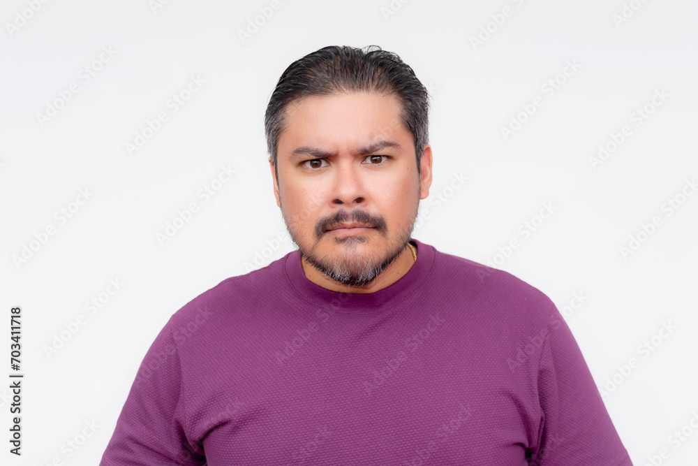 Fototapeta premium A middle aged man seems to be insulted by offensive remarks. Looking at the camera and seething in anger. Isolated on a white background.