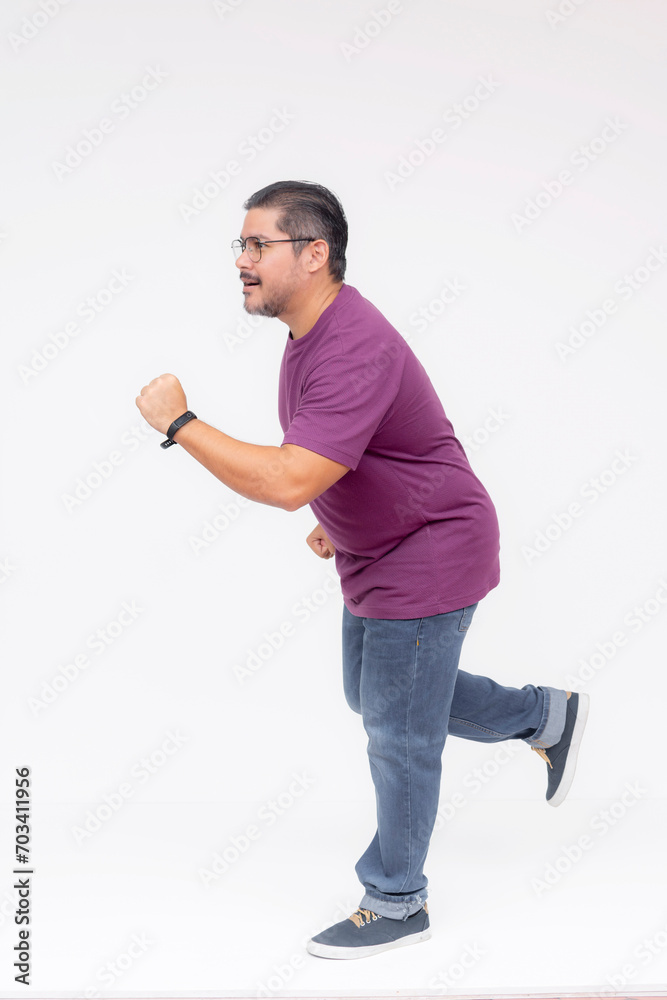Side view of a middle aged man running in hot pursuit to the left. Wearing a purple waffle shirt and jeans. Full body photo, isolated on a white background. Side view of a middle aged man running in hot pursuit to the left. Wearing a purple waffle shirt and jeans. Full body photo, isolated on a white background.