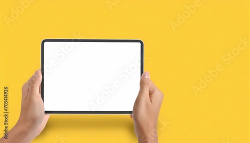 Hands holding white screen tablet, isolated on yellow background	
