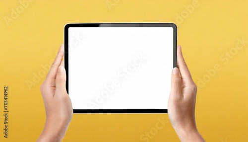 Hands holding white screen tablet, isolated on yellow background