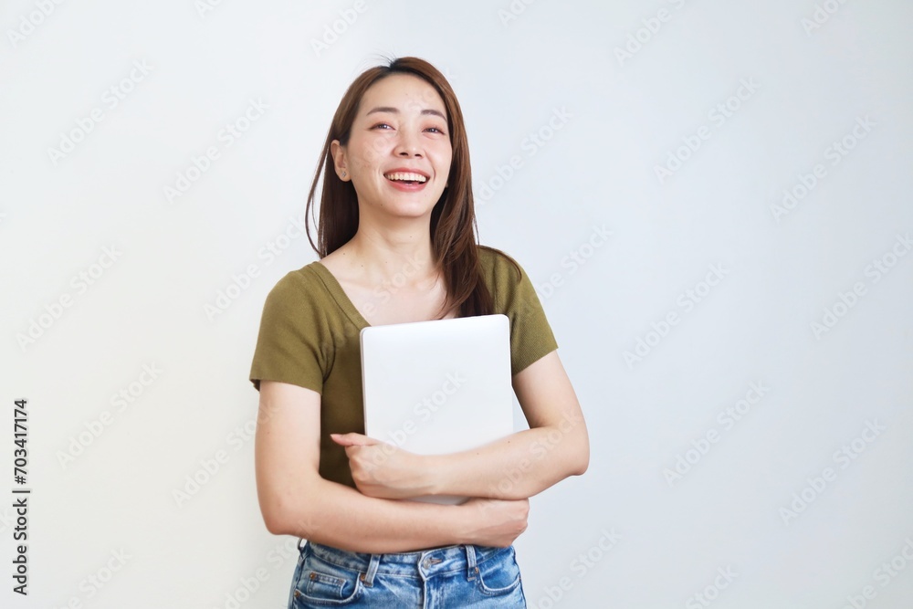portrait of a smiling woman holding laptop over isolated background. portrait of a smiling woman holding laptop over isolated background.