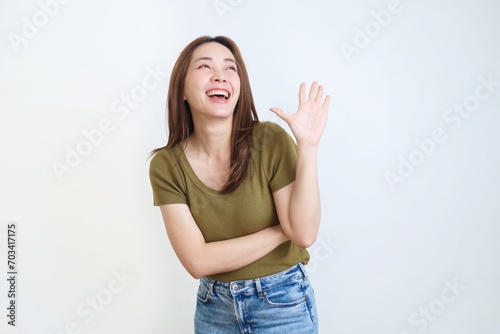 portrait of a smiling woman showing hand sign over isolated background.