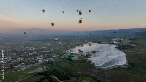 Hot air balloons and Natural travertine pools at sunrise in Pamukkale, 