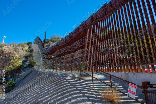 United States Mexico Border Wall between Nogales Arizona and Nogales Sonora on International Street in city of Nogales, Arizona AZ, USA.  photo