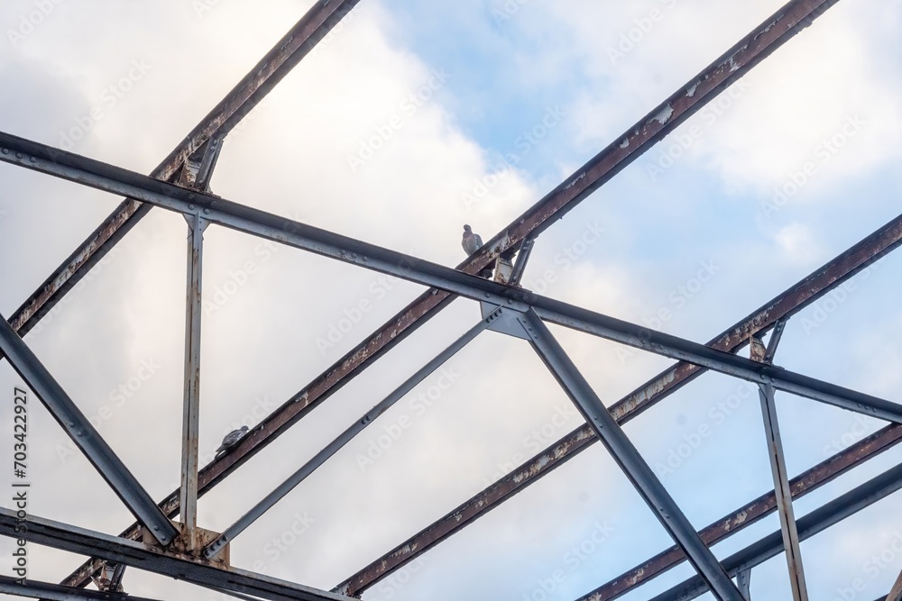 rusted roof truss of an old industrial building rusted roof truss of an old industrial building