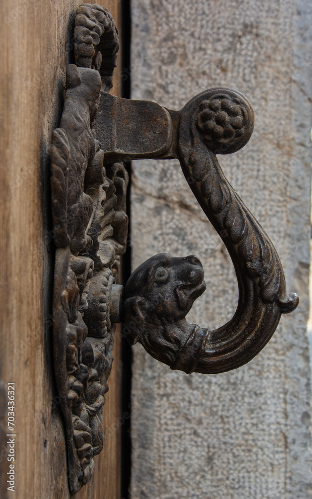 Side view of a heavy iron door handle carved in a form of a dog head in Spain Side view of a heavy iron door handle carved in a form of a dog head in Spain