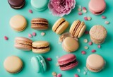 Colorful cake macaron or macaroon on turquoise pastel background from above French almond cookies