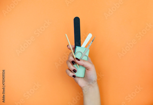 Crop woman with manicure supplies photo