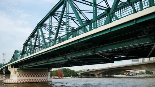 Traffic and bridge with metal structure over river, Saphan Phut (Memorial Bridge) in Bangkok photo