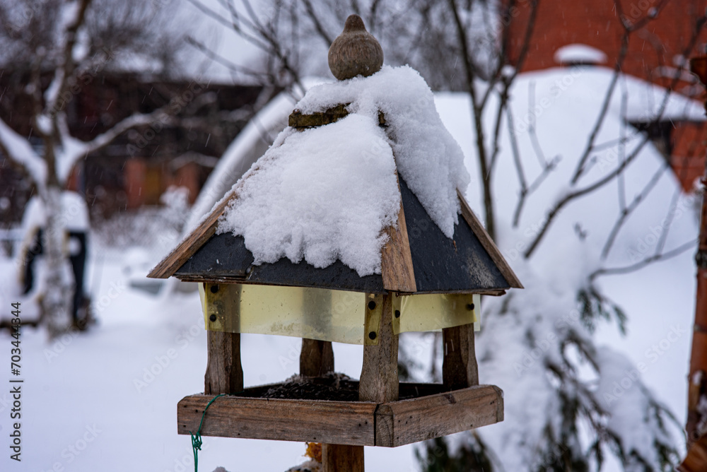 greenhouse covered with snow, trees, garden house and garden accessories greenhouse covered with snow, trees, garden house and garden accessories