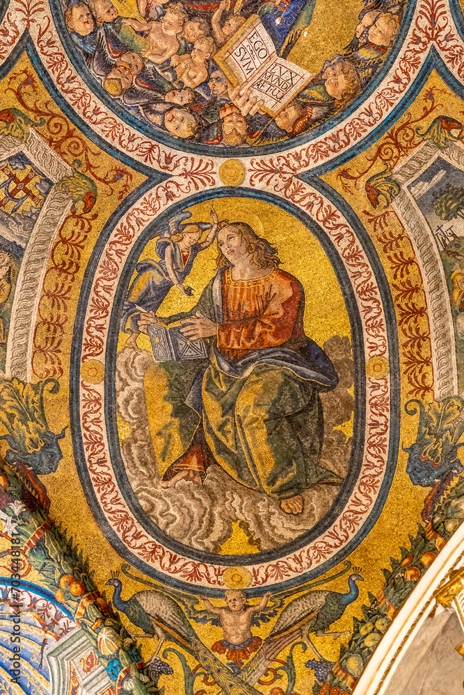 Close-up on colorful religious mosaic decorating interior of historic Basilica in Rome showing a saint