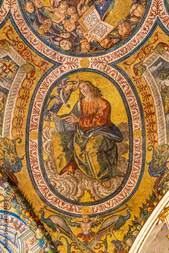 Close-up on colorful religious mosaic decorating interior of historic Basilica in Rome showing a saint