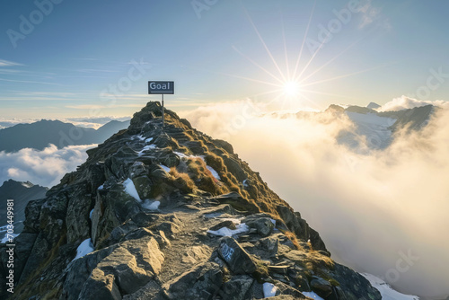 Goal concept image with goal board sign with written word at top of a mountain summit photo