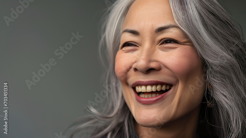 Beautiful senior female model with grey hair smiling
