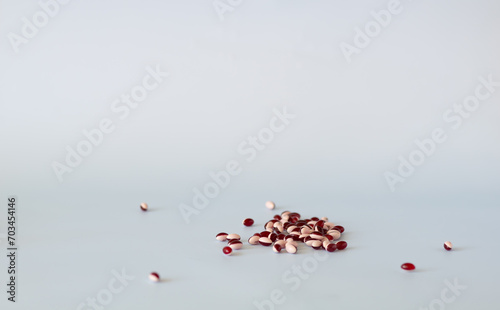 Scattered pills on a light background with copy space. Medication concept, pharmaceutical industry.