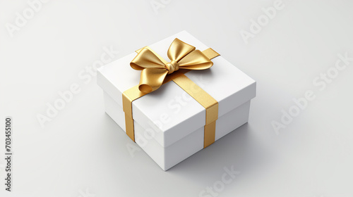 White present box with gold ribbon and bow isolated on grey white background.