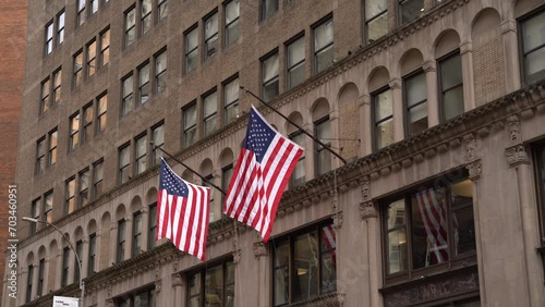 USA flag waving on old brown New York building