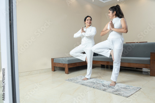 Indian woman Mother and Daughter doing exercise at home ,Mother and Daughter doing yoga poses at home