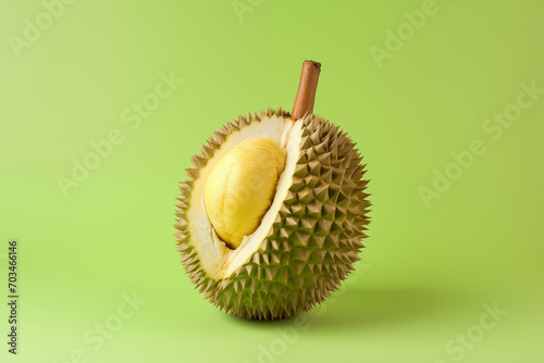 Durian fruit in front of pastel green backdrop.