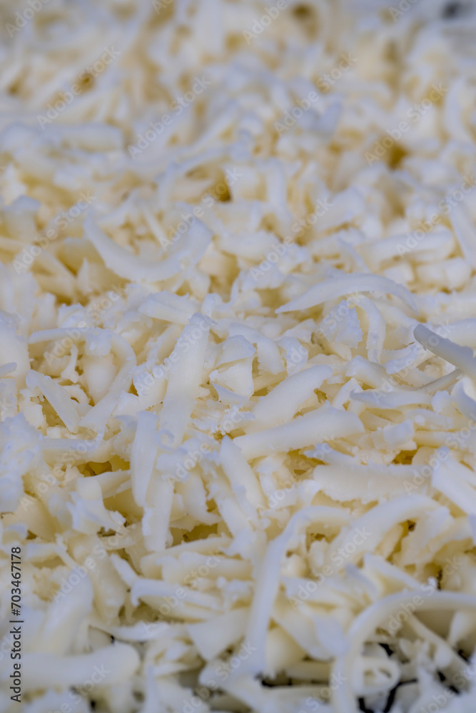 Obraz premium grated cheese in large quantities at home